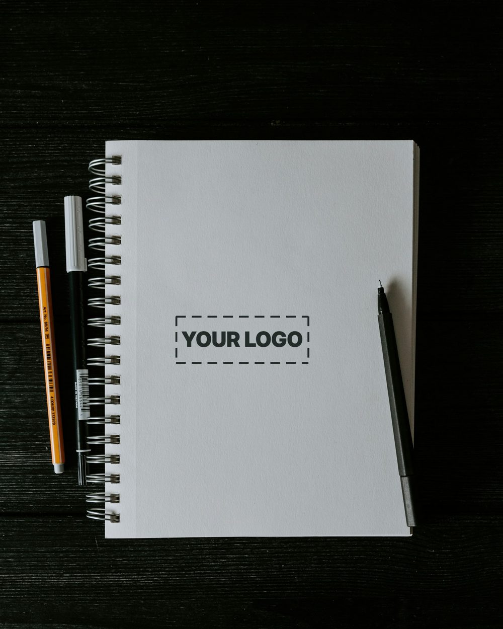Spiral journal and pens with a sample logo on the cover